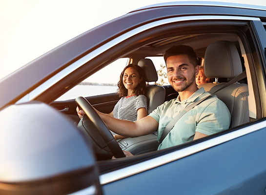 Dittmann Insurance_Personal & Commercial Insurance Southeast Kansas. Personal auto insurance, a family smiles from within their car.